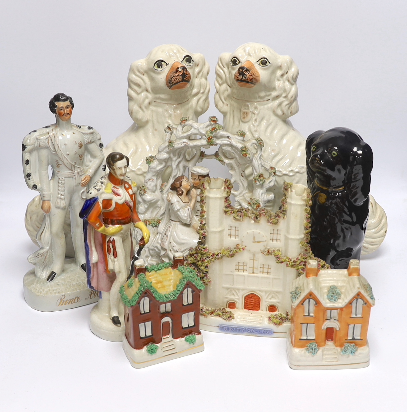 A mixed collection of Staffordshire figure groups to include various spaniels, a Prince Albert figure, courting couples and other bocage groups